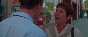 Movie still from “Halloween H20: 20 Years Later” (1998), directed by Steve Miner – A woman talking to a man in front of a car; Close Up shot, Low angle