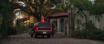 Movie still from “Halloween H20: 20 Years Later” (1998), directed by Steve Miner – A man standing next to a red truck on the side of the road; Extreme Wide shot, Low angle