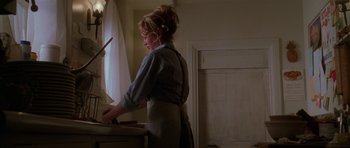 Movie still from “Halloween H20: 20 Years Later” (1998), directed by Steve Miner – A woman standing at a sink in a kitchen; Medium shot, Low angle