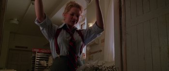 Movie still from “Halloween H20: 20 Years Later” (1998), directed by Steve Miner – A woman in a striped shirt and tie holding a glass; Medium shot, Low angle
