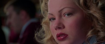 Movie still from “Halloween H20: 20 Years Later” (1998), directed by Steve Miner – The face of a woman with blonde curly hair; Close Up shot, Over the shoulder angle