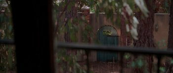 Movie still from “Halloween H20: 20 Years Later” (1998), directed by Steve Miner – A green gate in the middle of a yard; Extreme Wide shot, High angle