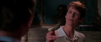 Movie still from “Halloween H20: 20 Years Later” (1998), directed by Steve Miner – A woman is holding a brush in her hand; Close Up shot, Over the shoulder angle