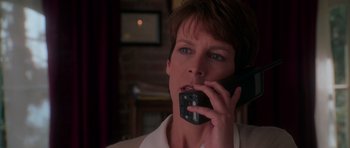 Movie still from “Halloween H20: 20 Years Later” (1998), directed by Steve Miner – A person talking on a cell phone; Close Up shot, Low angle