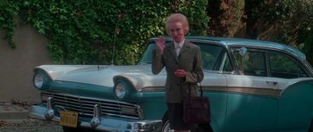 Movie still from “Halloween H20: 20 Years Later” (1998), directed by Steve Miner – An older woman standing next to an old car; Medium shot, Low angle