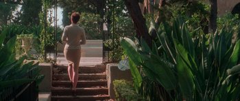 Movie still from “Halloween H20: 20 Years Later” (1998), directed by Steve Miner – A woman walking up some stairs in a garden; Wide shot, High angle