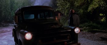 Movie still from “Halloween H20: 20 Years Later” (1998), directed by Steve Miner – An old truck is parked on the side of the road; Wide shot, Low angle
