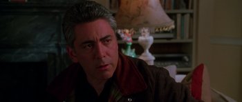 Movie still from “Halloween H20: 20 Years Later” (1998), directed by Steve Miner – A person sitting in a room near a lamp; Close Up shot, Over the shoulder angle