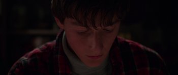 Movie still from “Halloween H20: 20 Years Later” (1998), directed by Steve Miner – A young boy is looking down at his face; Close Up shot, High angle