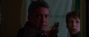 Movie still from “Halloween H20: 20 Years Later” (1998), directed by Steve Miner – A person holding a gun; Close Up shot, Low angle