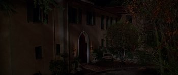 Movie still from “Halloween H20: 20 Years Later” (1998), directed by Steve Miner – A house that is lit up at night time; Extreme Wide shot, High angle