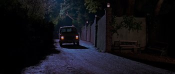 Movie still from “Halloween H20: 20 Years Later” (1998), directed by Steve Miner – A car driving down a street at night; Wide shot, High angle