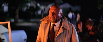 Movie still from “Halloween II” (1981), directed by Rick Rosenthal – A man in a trench coat and a tie; Close Up shot, Low angle