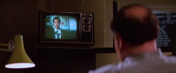 Movie still from “Halloween II” (1981), directed by Rick Rosenthal – A man sitting in front of an old television; Extreme Close Up shot, Over the shoulder angle