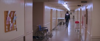 Movie still from “Halloween II” (1981), directed by Rick Rosenthal – A person pushing a cart in a hospital hallway; Wide shot, High angle