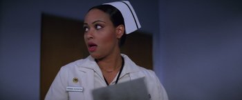 Movie still from “Halloween II” (1981), directed by Rick Rosenthal – A woman wearing a nurse's uniform and holding a book; Close Up shot, Low angle