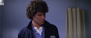 Movie still from “Halloween II” (1981), directed by Rick Rosenthal – A young man with curly brown hair wearing a jacket; Close Up shot, Low angle