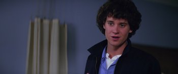 Movie still from “Halloween II” (1981), directed by Rick Rosenthal – A young man in a blue shirt and a black jacket; Close Up shot, Low angle