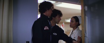 Movie still from “Halloween II” (1981), directed by Rick Rosenthal – Two men and a woman standing next to each other; Medium shot, Over the shoulder angle