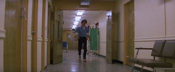 Movie still from “Halloween II” (1981), directed by Rick Rosenthal – A man walking down a hall way in a hospital; Wide shot, Low angle