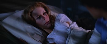 Movie still from “Halloween II” (1981), directed by Rick Rosenthal – A woman laying in a bed with her eyes closed; Close Up shot, High angle