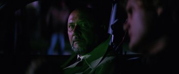 Movie still from “Halloween II” (1981), directed by Rick Rosenthal – A person wearing a suit and tie; Close Up shot, Low angle