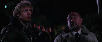 Movie still from “Halloween II” (1981), directed by Rick Rosenthal – Two men standing next to each other at night; Close Up shot, Over the shoulder angle