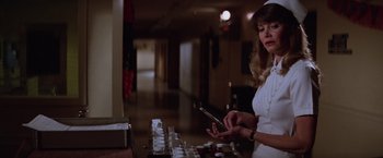Movie still from “Halloween II” (1981), directed by Rick Rosenthal – A woman in a white dress holding a cell phone in her hand; Close Up shot, Low angle