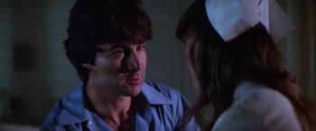 Movie still from “Halloween II” (1981), directed by Rick Rosenthal – A man and a woman talking to each other; Close Up shot, Low angle