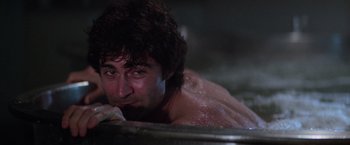Movie still from “Halloween II” (1981), directed by Rick Rosenthal – A man with wet hair laying in a bath tub; Close Up shot, Low angle