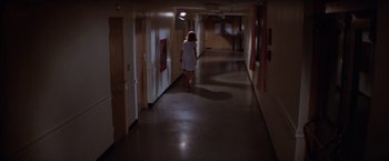 Movie still from “Halloween II” (1981), directed by Rick Rosenthal – A woman walking down a long hallway in a building; Wide shot, High angle