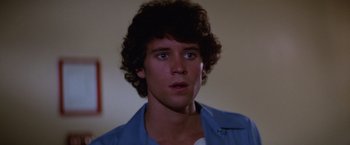 Movie still from “Halloween II” (1981), directed by Rick Rosenthal – A young man with curly brown hair and blue eyes; Close Up shot, Low angle