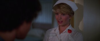 Movie still from “Halloween II” (1981), directed by Rick Rosenthal – A woman in a nurse's uniform with a tomato on her head; Close Up shot, Over the shoulder angle