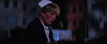 Movie still from “Halloween II” (1981), directed by Rick Rosenthal – A woman wearing a nurse's hat and a jacket; Close Up shot, Low angle