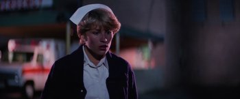 Movie still from “Halloween II” (1981), directed by Rick Rosenthal – A woman wearing a nurse's hat and a jacket; Close Up shot, Low angle
