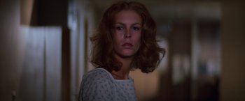 Movie still from “Halloween II” (1981), directed by Rick Rosenthal – A beautiful woman with brown curly hair and blue eyes; Close Up shot, Low angle