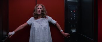 Movie still from “Halloween II” (1981), directed by Rick Rosenthal – A woman in a white dress with blood all over her body; Medium shot, Low angle