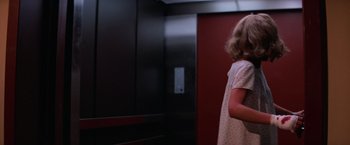 Movie still from “Halloween II” (1981), directed by Rick Rosenthal – A little girl standing in front of an elevator in a room; Medium shot, Low angle