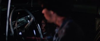 Movie still from “Halloween II” (1981), directed by Rick Rosenthal – A man and a woman in a car at night; Close Up shot, Over the shoulder angle