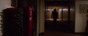 Movie still from “Halloween II” (1981), directed by Rick Rosenthal – A man walking down a hall way in a building; Wide shot, Low angle