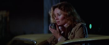 Movie still from “Halloween II” (1981), directed by Rick Rosenthal – A woman holding a camera in her hands; Close Up shot, High angle