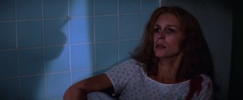 Movie still from “Halloween II” (1981), directed by Rick Rosenthal – A woman sitting in front of a tiled wall; Close Up shot, Low angle
