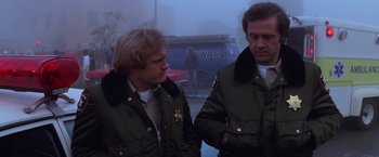 Movie still from “Halloween II” (1981), directed by Rick Rosenthal – A couple of men standing next to each other; Medium shot, Low angle