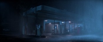 Movie still from “Halloween III: Season of the Witch” (1982), directed by Tommy Lee Wallace – An empty gas station at night in the dark; Extreme Wide shot, Low angle