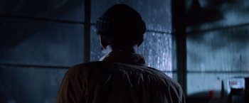 Movie still from “Halloween III: Season of the Witch” (1982), directed by Tommy Lee Wallace – A person standing in front of a window in the rain; Close Up shot, Over the shoulder angle