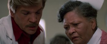 Movie still from “Halloween III: Season of the Witch” (1982), directed by Tommy Lee Wallace – A man and a woman looking at one another; Close Up shot, Over the shoulder angle