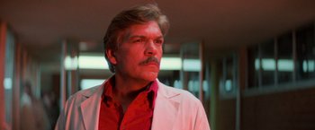 Movie still from “Halloween III: Season of the Witch” (1982), directed by Tommy Lee Wallace – A person wearing a lab coat; Close Up shot, Low angle