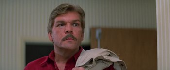 Movie still from “Halloween III: Season of the Witch” (1982), directed by Tommy Lee Wallace – A person wearing a jacket; Close Up shot, Low angle