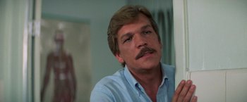 Movie still from “Halloween III: Season of the Witch” (1982), directed by Tommy Lee Wallace – A person with a mustache; Close Up shot, Low angle