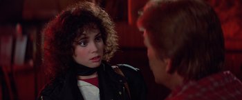 Movie still from “Halloween III: Season of the Witch” (1982), directed by Tommy Lee Wallace – A woman with curly hair talking to a man; Close Up shot, Over the shoulder angle